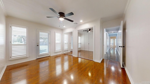 unfurnished bedroom featuring crown molding, hardwood / wood-style floors, and ceiling fan