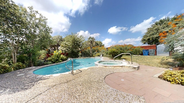 view of swimming pool with a patio and an in ground hot tub