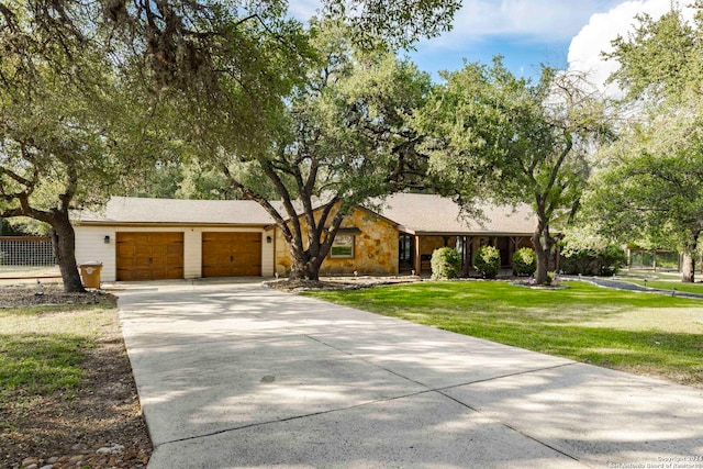 ranch-style home with a garage and a front yard