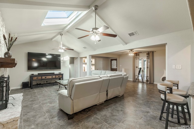 living room featuring a skylight, tile patterned flooring, beamed ceiling, ceiling fan, and high vaulted ceiling