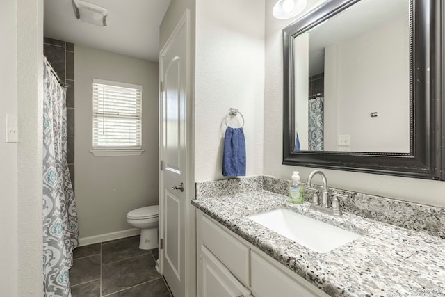 bathroom with tile patterned flooring, vanity, and toilet