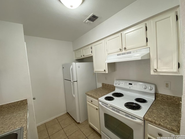 kitchen featuring light tile patterned floors and white appliances