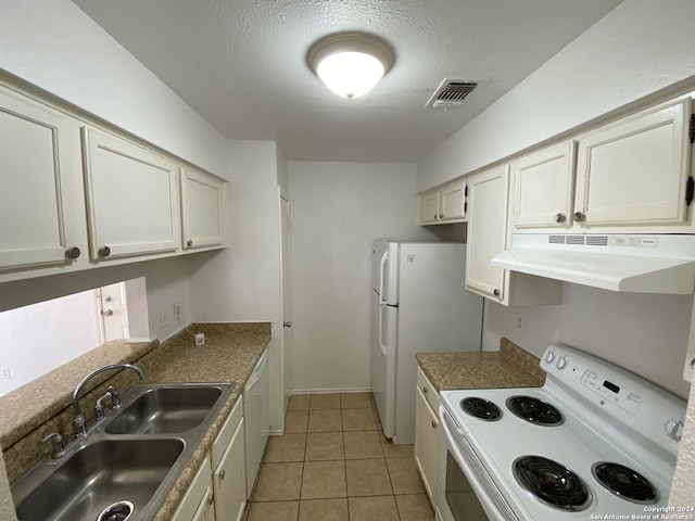 kitchen with white appliances, sink, a textured ceiling, range hood, and light tile patterned flooring