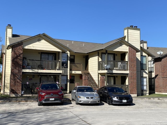 view of building exterior featuring uncovered parking