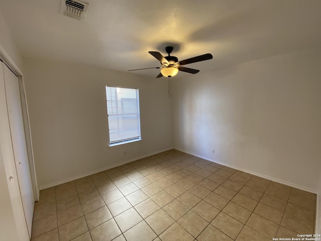 unfurnished bedroom with a closet, baseboards, visible vents, and a ceiling fan