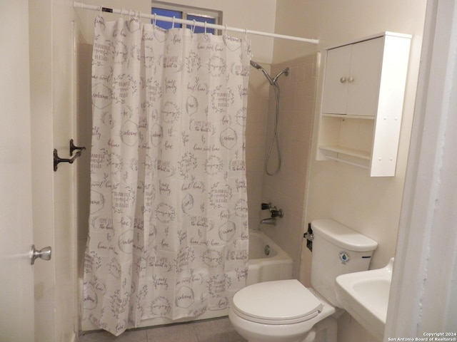 bathroom with tile patterned flooring, a sink, toilet, and shower / bath combo with shower curtain