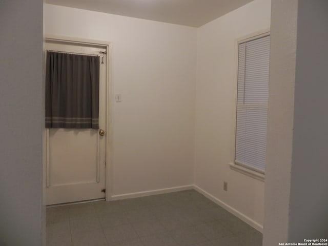 spare room featuring tile patterned flooring