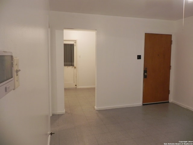 unfurnished room with light tile patterned floors