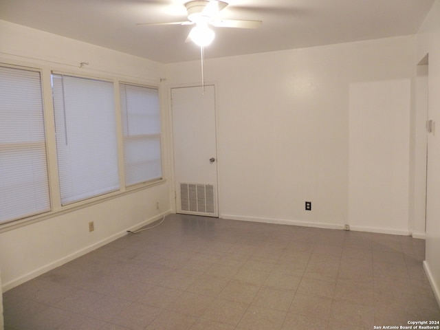 spare room featuring ceiling fan and tile patterned floors