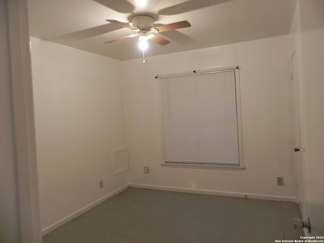 tiled spare room featuring ceiling fan