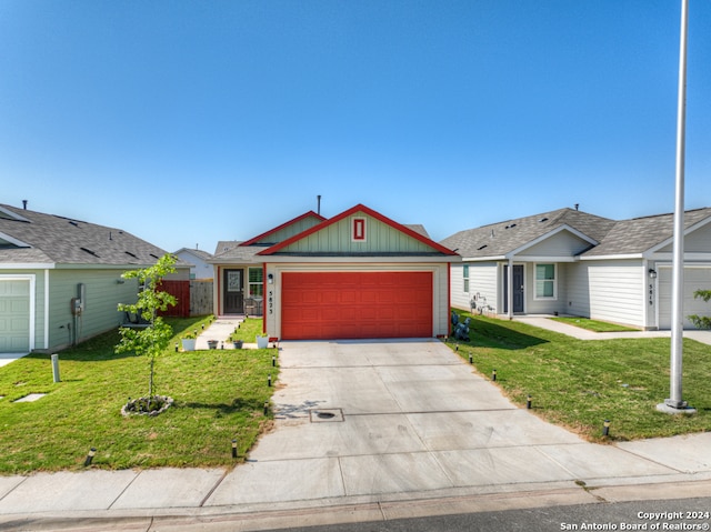 ranch-style home with a front yard and a garage