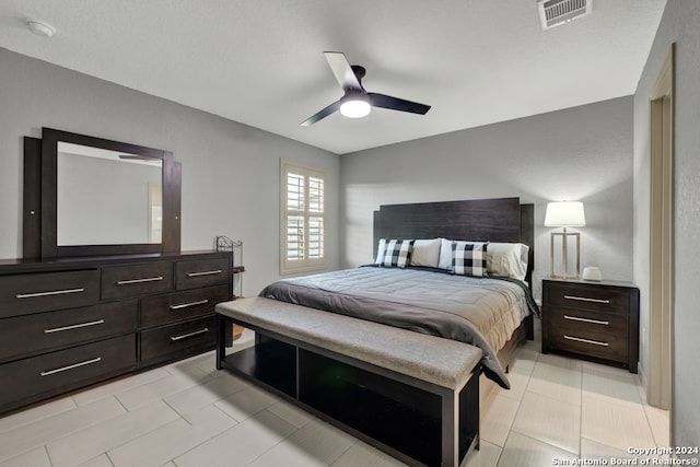 tiled bedroom with ceiling fan