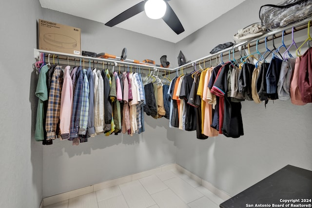 walk in closet with ceiling fan and light tile patterned floors