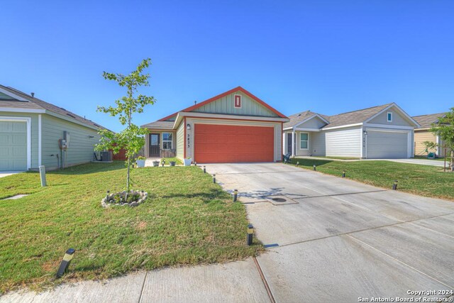 ranch-style house with a front lawn, central AC, and a garage