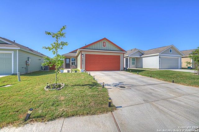 view of front of house with a garage, driveway, and a front lawn