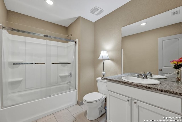 bathroom with toilet, shower / bath combination with glass door, visible vents, and vanity