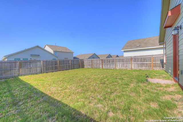 view of yard with a fenced backyard