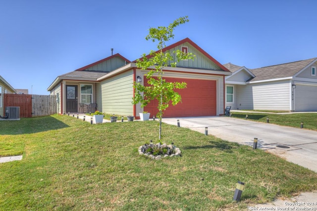 ranch-style home featuring cooling unit, a garage, driveway, a front lawn, and board and batten siding