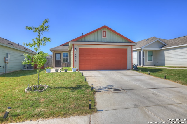 view of front of property with a garage and a front lawn