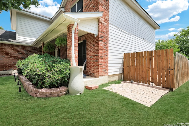 view of side of home featuring a yard