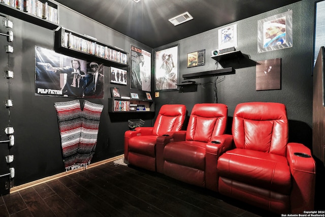 cinema room featuring dark wood-type flooring