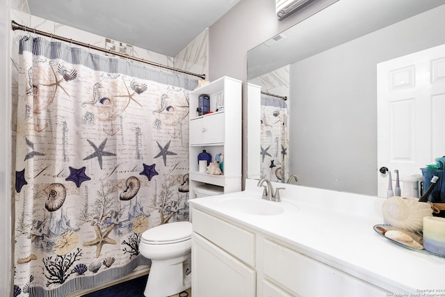 bathroom with toilet and vanity