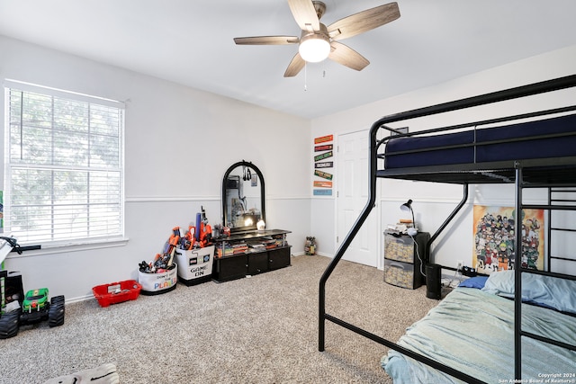 bedroom with ceiling fan and carpet floors