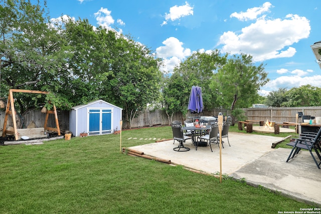 view of yard featuring a patio area and a storage unit