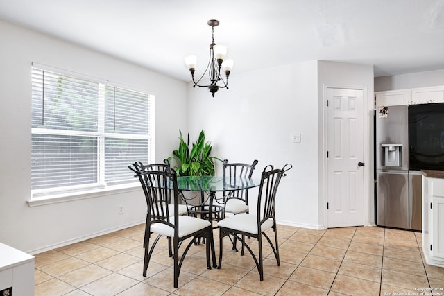 tiled dining area with a chandelier