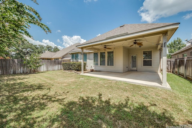 back of house featuring a yard, a patio area, and ceiling fan