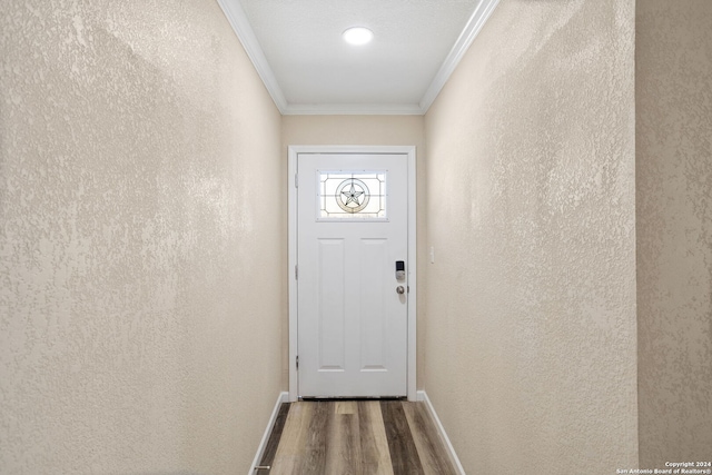 doorway with crown molding and hardwood / wood-style flooring