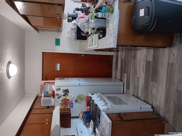 kitchen featuring fridge, tile patterned flooring, and separate washer and dryer