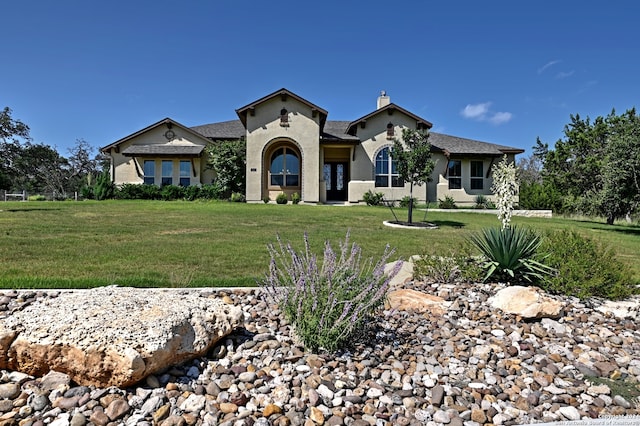 mediterranean / spanish home featuring a front lawn