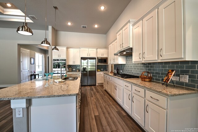 kitchen featuring tasteful backsplash, appliances with stainless steel finishes, white cabinetry, sink, and dark wood-type flooring