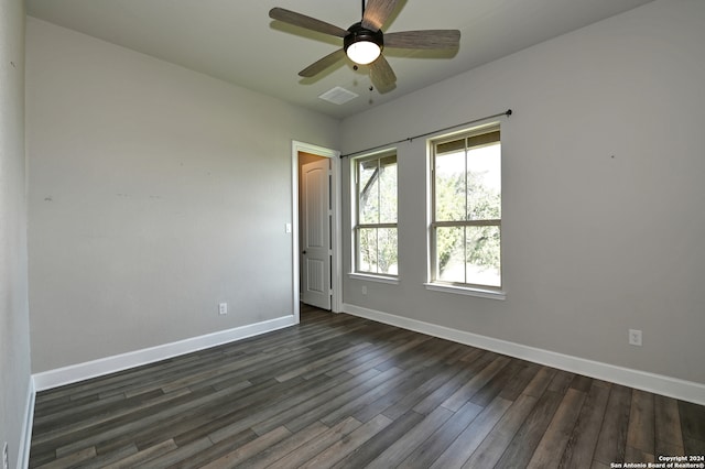 unfurnished room with dark hardwood / wood-style flooring and ceiling fan