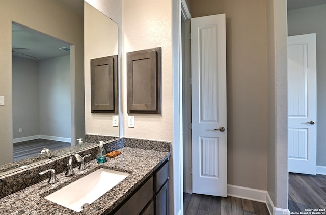 bathroom with ceiling fan, vanity, and wood-type flooring