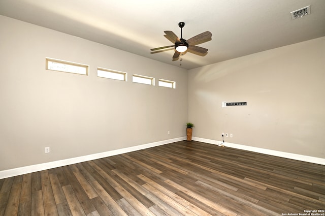 spare room with ceiling fan and dark wood-type flooring