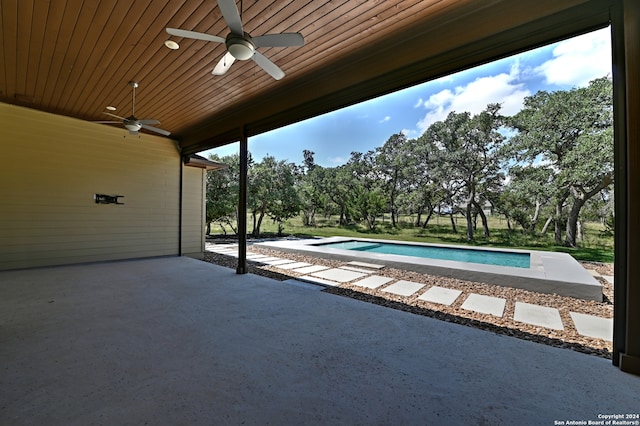 view of swimming pool featuring ceiling fan and a patio area