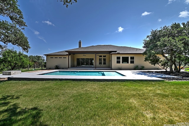 rear view of house with a yard and a patio area