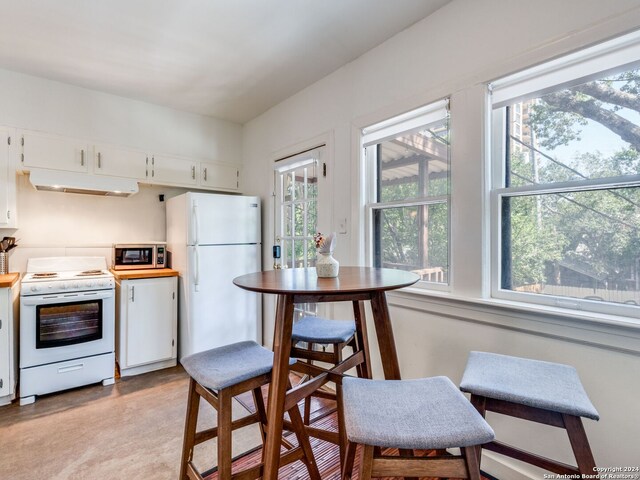 kitchen with white appliances and white cabinetry