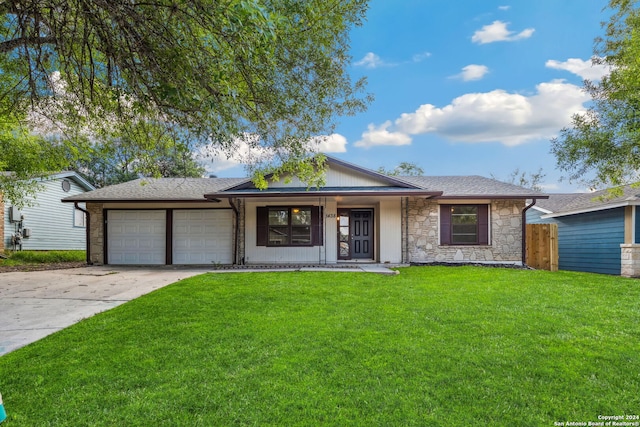 single story home with a garage and a front yard