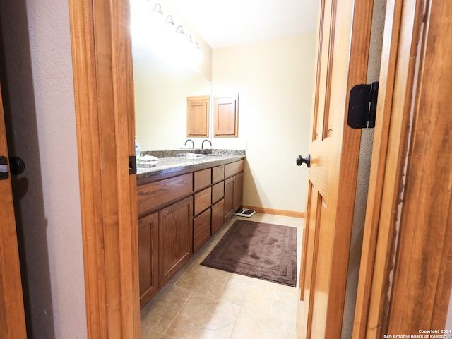 bathroom with double sink vanity and tile patterned floors