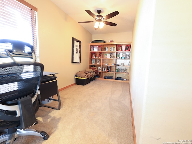 carpeted office space featuring ceiling fan