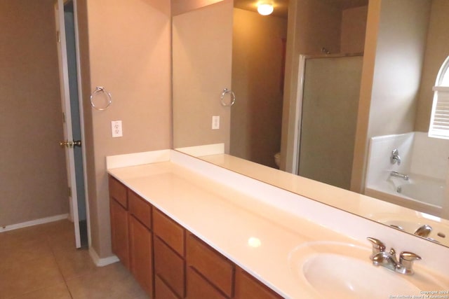 full bathroom with tile patterned flooring, toilet, vanity, baseboards, and a bath