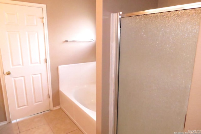 full bathroom featuring a stall shower, tile patterned flooring, and a bath