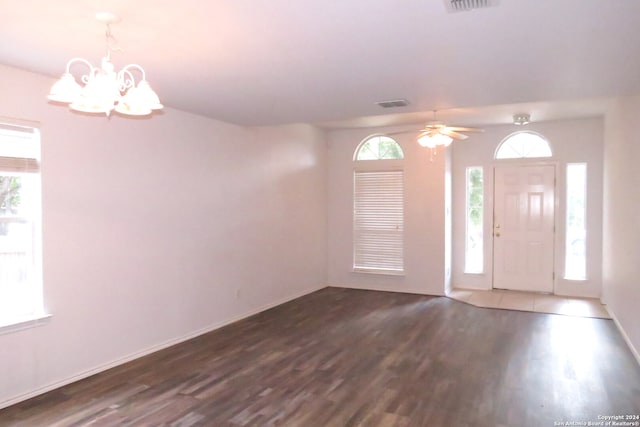 foyer entrance with hardwood / wood-style floors, ceiling fan with notable chandelier, and a wealth of natural light