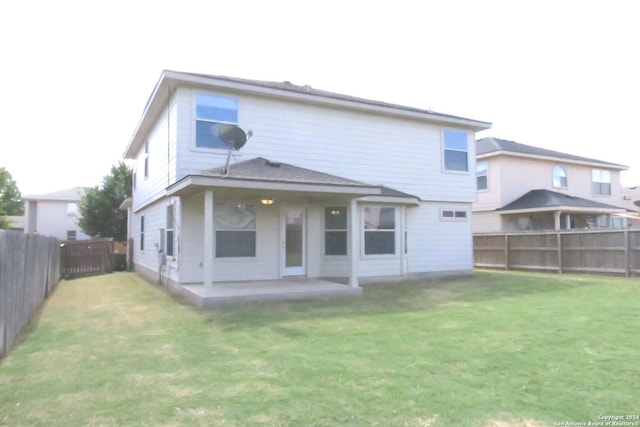 back of house featuring a patio area, a lawn, and a fenced backyard