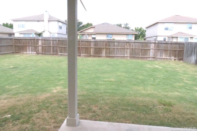 view of yard with a fenced backyard and a residential view