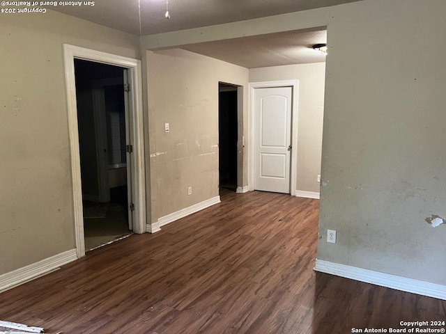 unfurnished room featuring dark hardwood / wood-style flooring