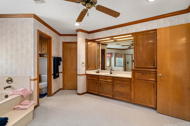 bathroom featuring a textured ceiling, toilet, ceiling fan, ornamental molding, and vanity